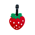 Porte-nom Gravipack fraise « Ramène ta fraise » sur la face avant d’une valise ou d’un sac à dos