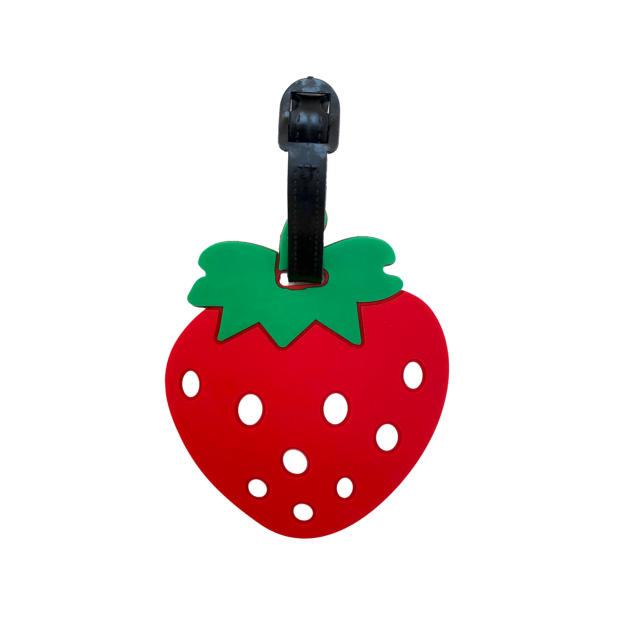 Porte-nom Gravipack fraise « Ramène ta fraise » sur la face avant d’une valise ou d’un sac à dos