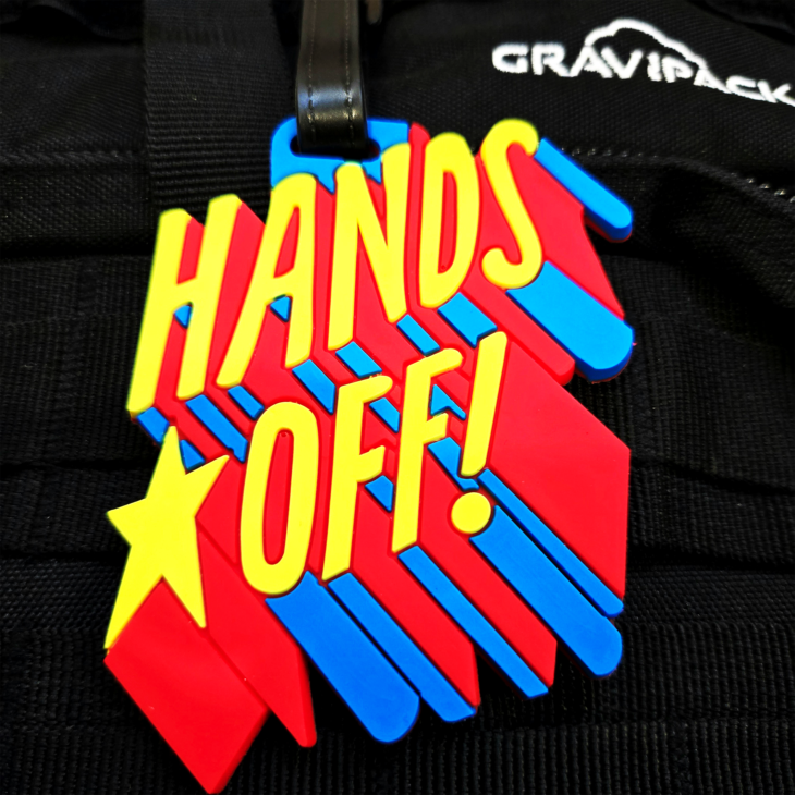 Porte-nom pour valise, sac à dos et bagage Gravipack avec message « Hands Off »